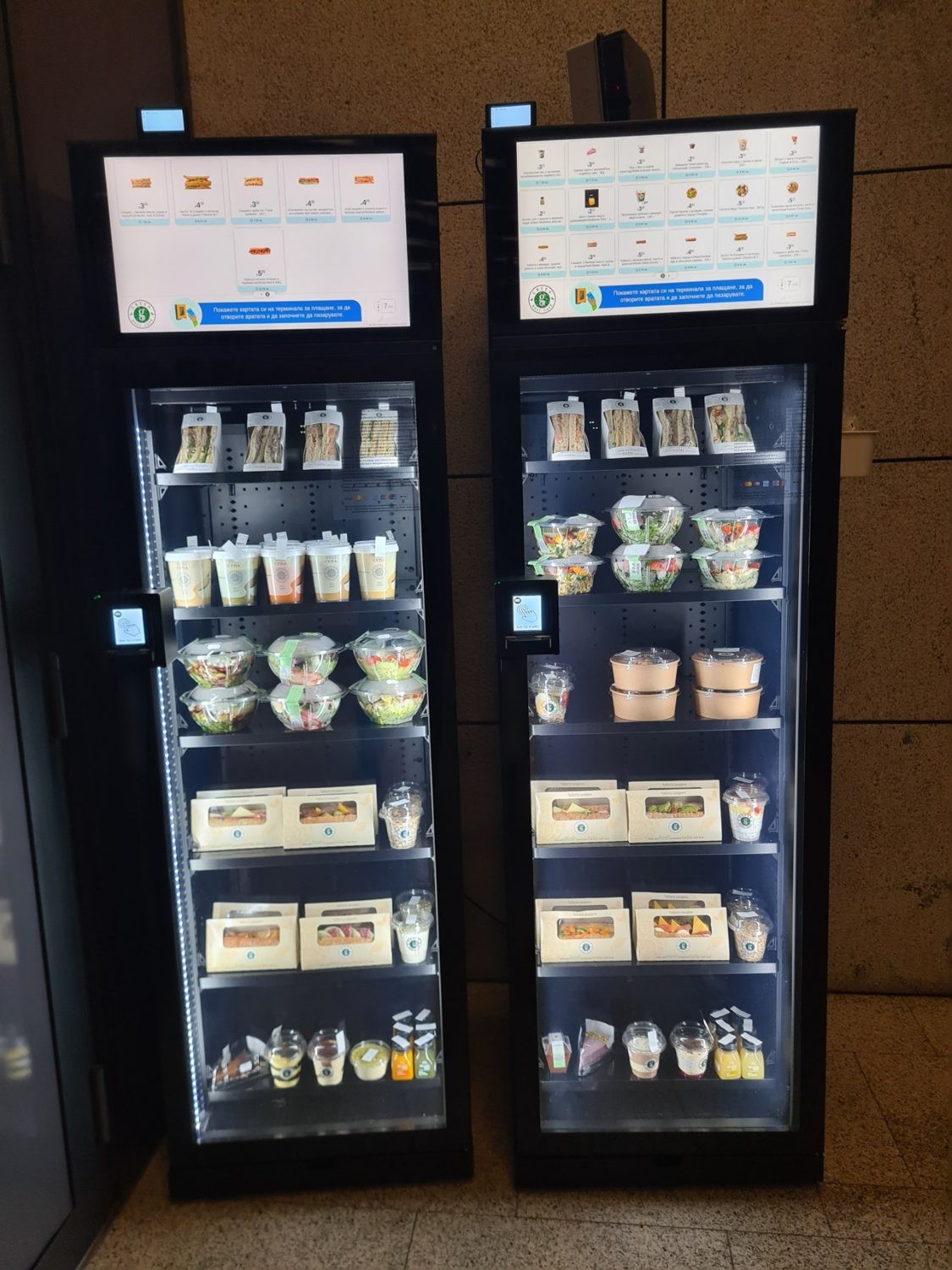 Two stocked fridges in a building